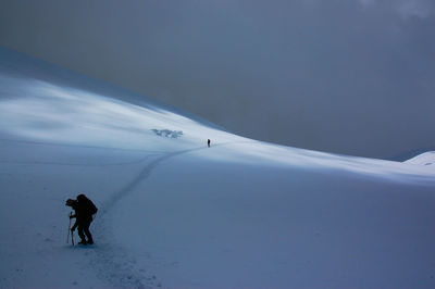 Full length of person standing on snowcapped mountain against sky