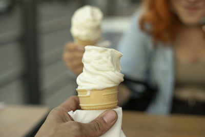 Hand holding ice cream cone