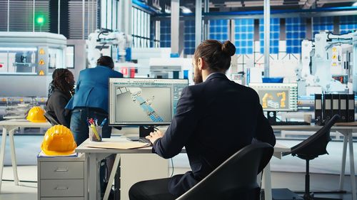 Rear view of business people working in office
