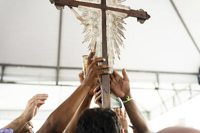 Group of people holding the cross of jesus christ