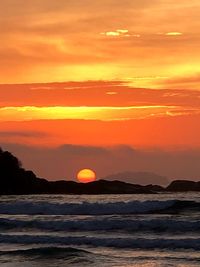 Scenic view of sea against romantic sky at sunset