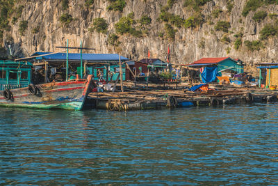 Fishing boats moored on sea