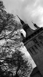 Low angle view of tree and building against sky