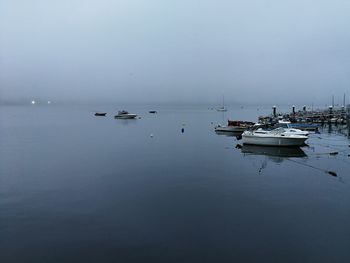 Boats in sea against sky