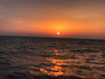 Scenic view of sea against romantic sky at sunset