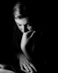 Portrait of baby girl over black background