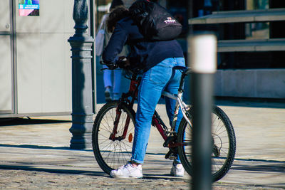 Man riding bicycle on city street