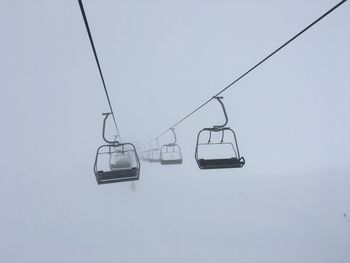 Overhead cable car against sky during winter