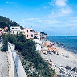 People on beach against sky