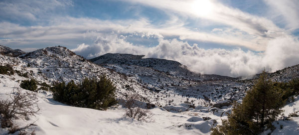 Scenic view of snow covered mountains against sky