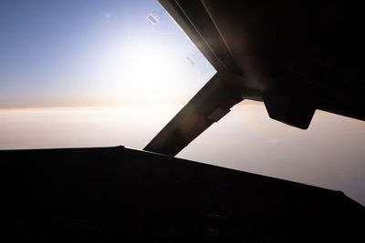 Silhouette of airplane flying in sky