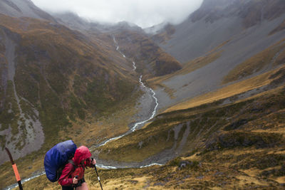 High angle view of woman hiking against valley