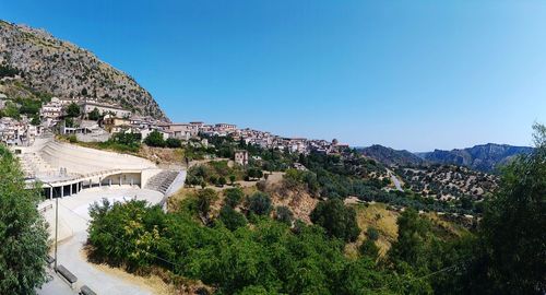 High angle view of buildings against blue sky