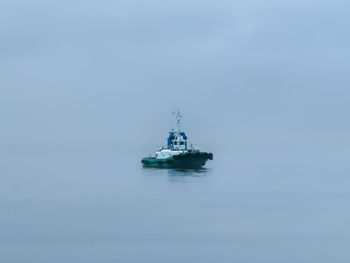 Sailboat in sea against sky