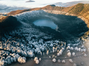 Aerial view of frozen trees and volcano lake.majestic sunrise in the mountains