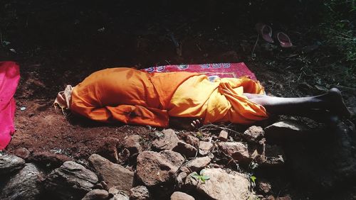 Midsection of man lying down on floor