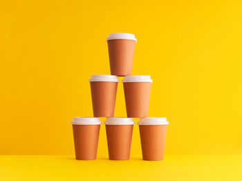 Close-up of coffee cup against yellow background