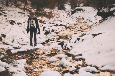 Woman at stream in forest