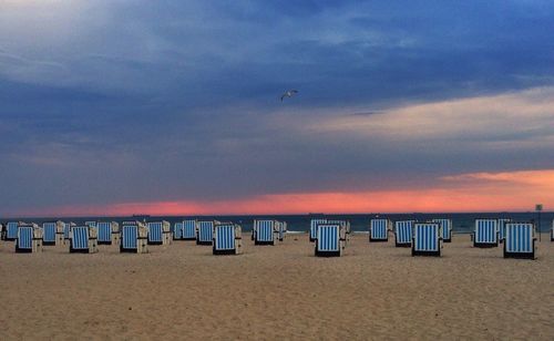 Scenic view of beach against cloudy sky