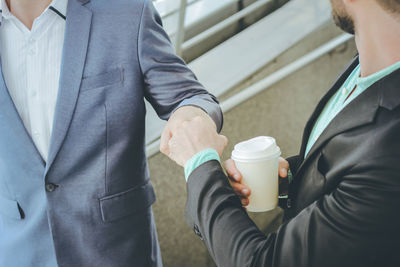Close-up of woman holding coffee cup