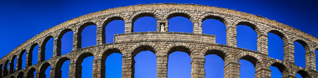 Low angle view of historical building against blue sky