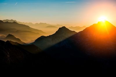 Scenic view of silhouette mountains against sky during sunset