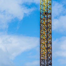 Low angle view of crane against sky