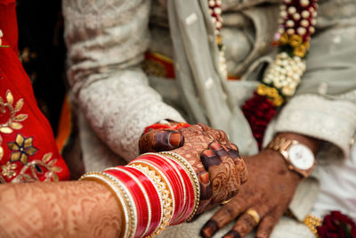 Midsection of bride with henna tattoo
