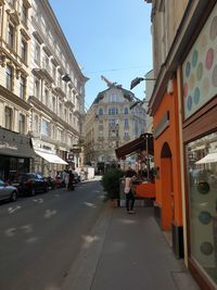 Street amidst buildings in city against sky