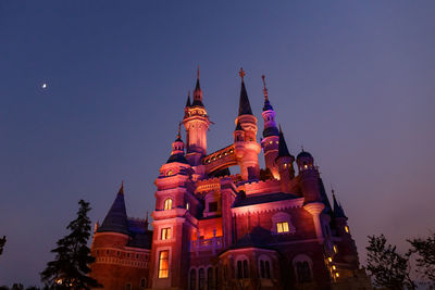 Low angle view of illuminated building against sky