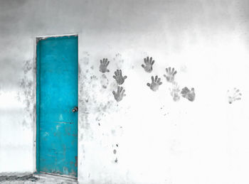 Close-up of blue window on white wall