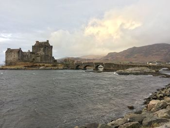 Historic building by sea against sky