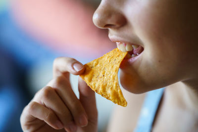 Close-up of woman eating burger