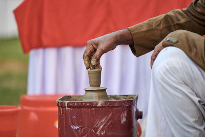 Midsection of man holding water pipe