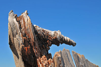 Low angle view of old ruins against clear blue sky