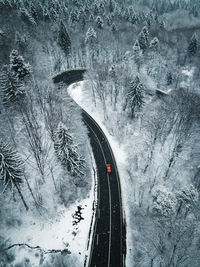 Aerial view of road amidst snow covered land during winter