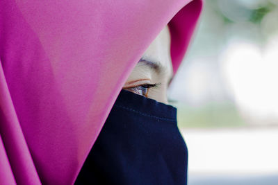 Close-up of woman with pink umbrella