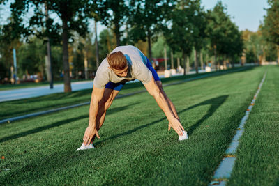 Full length of man climbing on grass