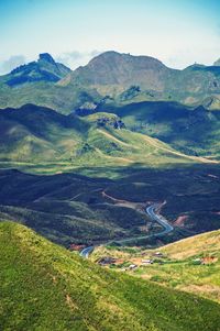 Scenic view of field and mountains against sky