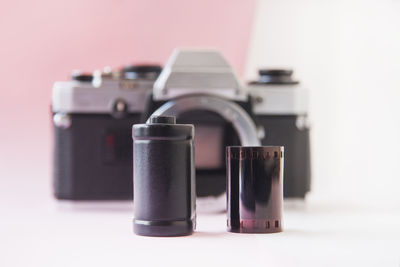 Close-up of camera on table against white background