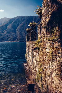 Surrounding wall by river against mountain