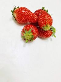 High angle view of strawberries on table against white background