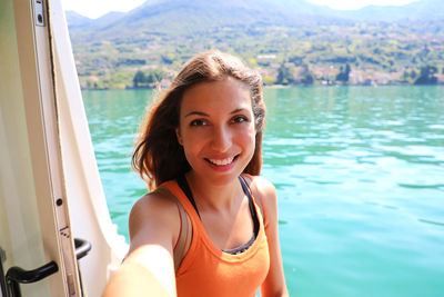 Portrait of smiling young woman in water