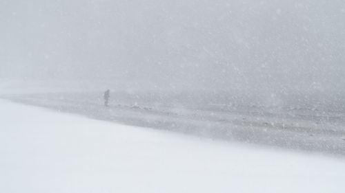 Snow covered landscape against sky