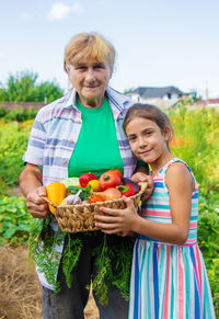 Portrait of smiling young woman holding pumpkin