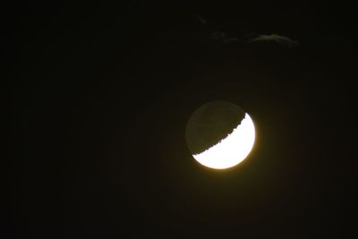 Low angle view of moon against dark sky