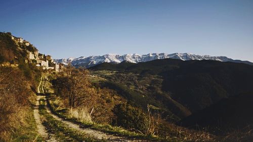 Countryside landscape against clear blue sky