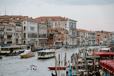 Boats in canal against buildings in city