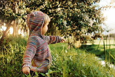 Rear view of girl on field