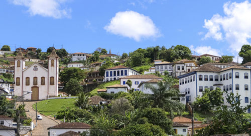 Buildings in town against sky